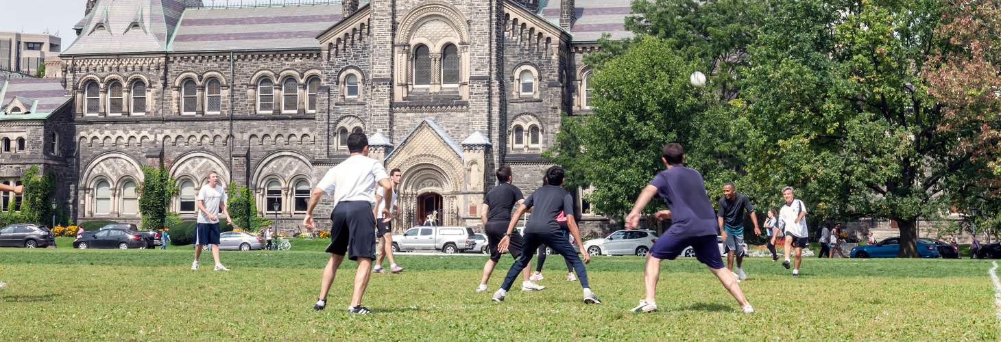 Students Playing Soccer in front of UC Building