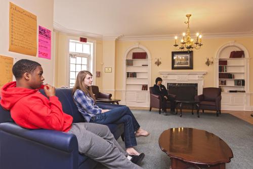 3 Students watch TV in the Whitney Hall common area