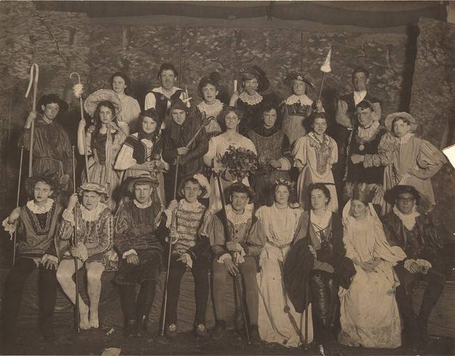 Group portrait of about 25 actors in costume.