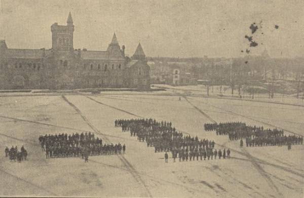 Distant view of rows of soldiers with University College in background