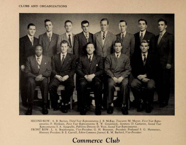 Yearbook photo of thirteen men in suits, captioned "Commerce Club"