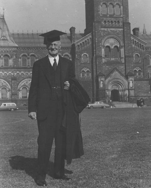 Malcolm Wallace wearing mortarboard in front of University College