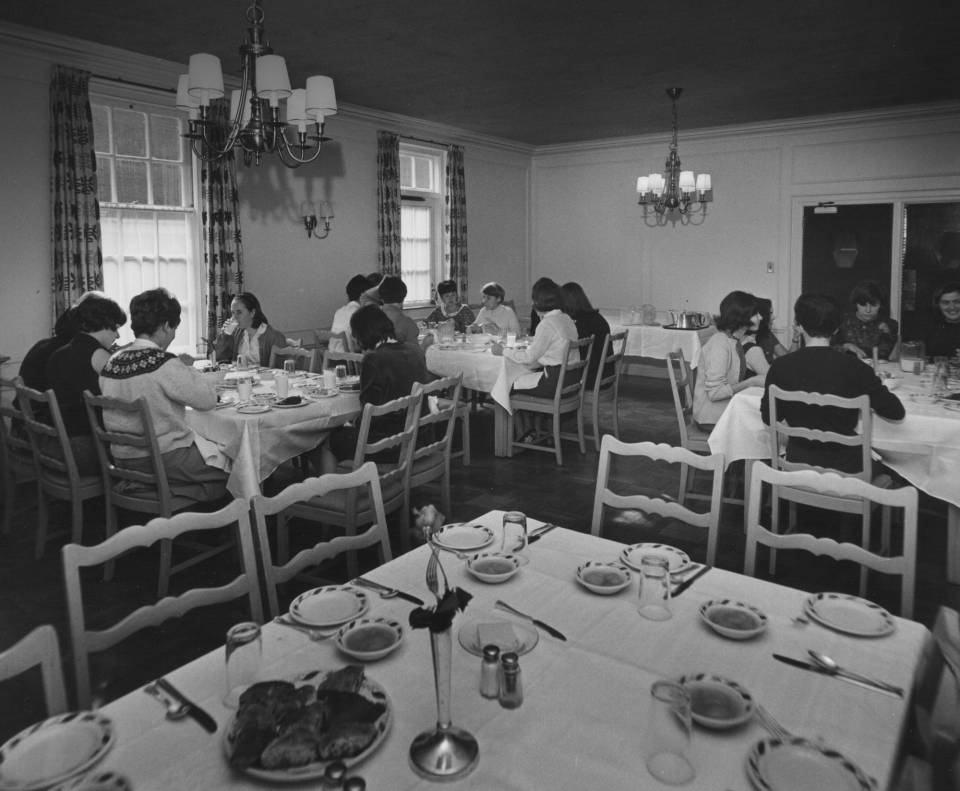 About 15 women eating at dining tables