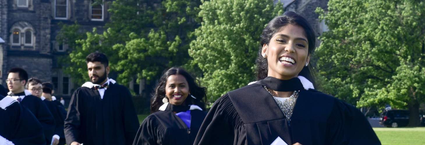 Students in front of University College during spring convocation dressed in their gowns