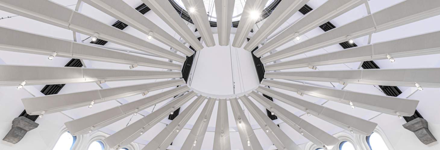 A large, geometric, white chandelier photographed from below