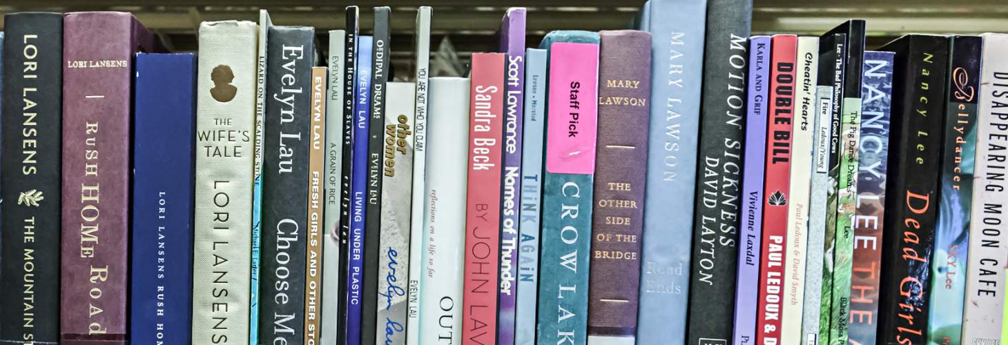 shelf of books including one with a "Staff Pick" label