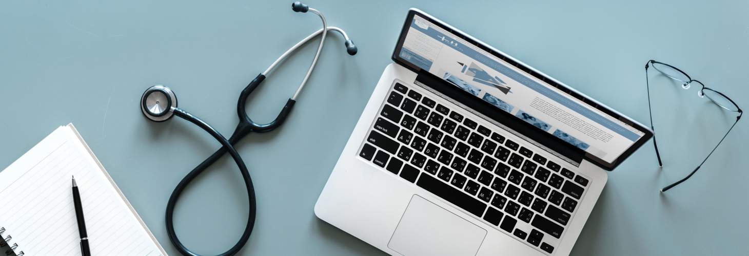 Stethoscope & computer on desk