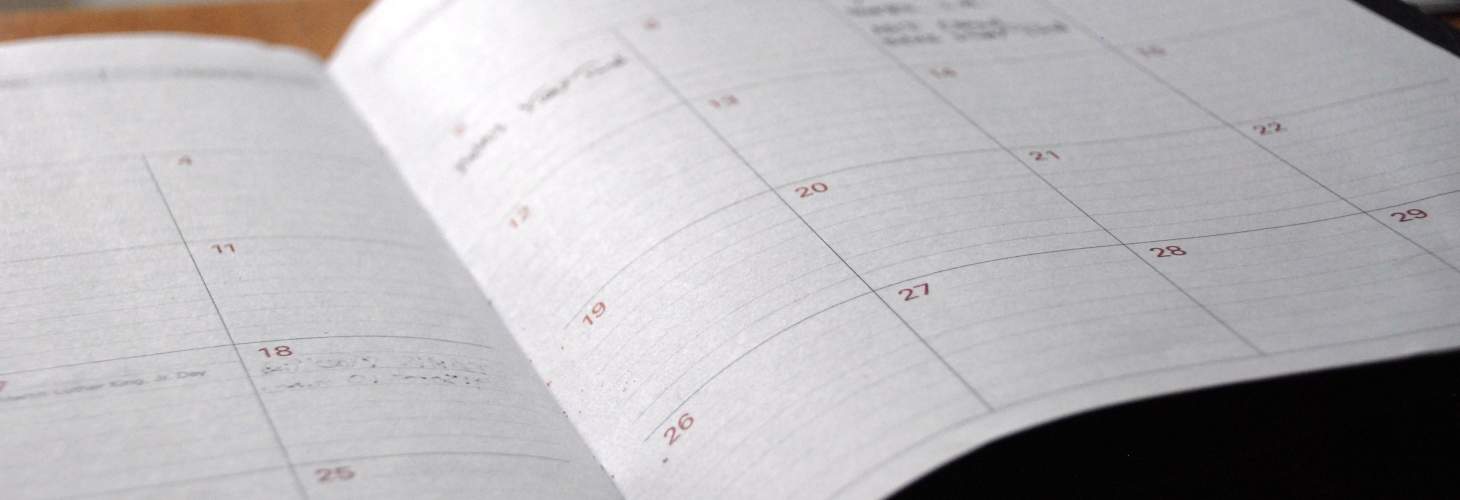 Calendar planner laying on top of a desk