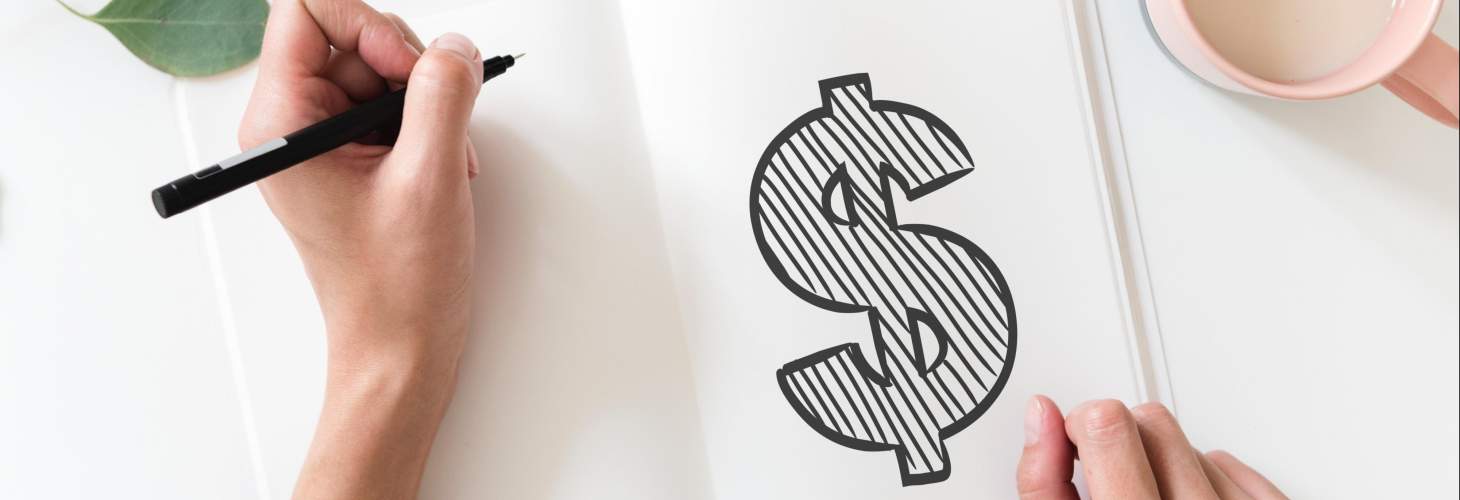 Left-handed student drawing a money sign in a notebook
