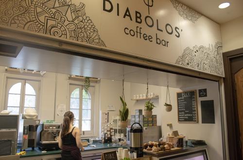 Barista standing behind coffee counter