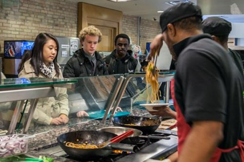 Students ordering food at the stir-fry station
