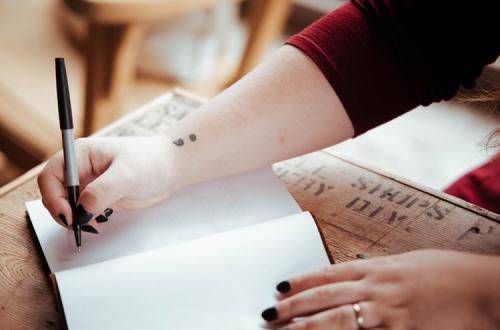 Person writing in a book