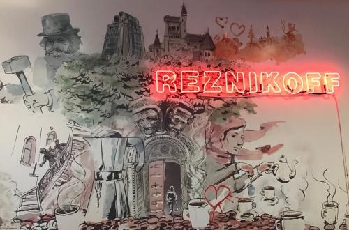 Red neon sign reads: Reznikoff