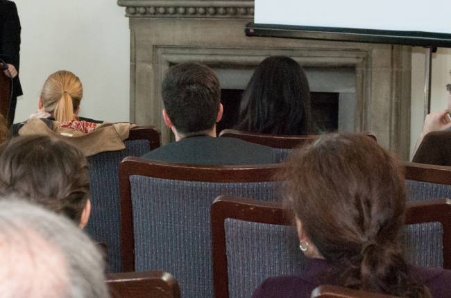 Audience watches a conference presentation