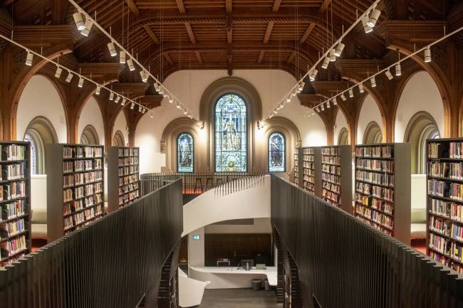 Large library with wood ceiling, stained glass, and spiral staircase