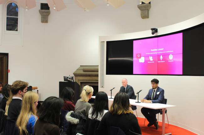 Student audience in in a conference centre viewing a panel discussion