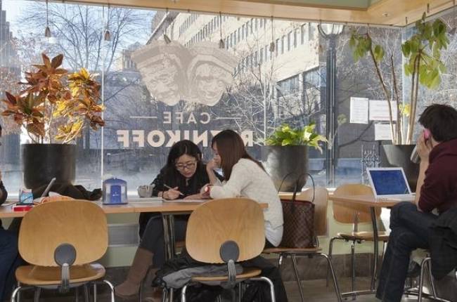 Students sitting in front of the café window