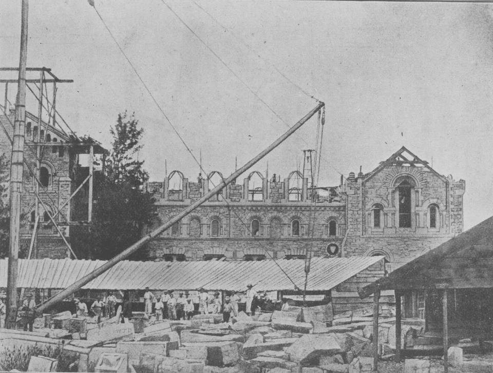 UC exterior under construction with blocks of stone and workers