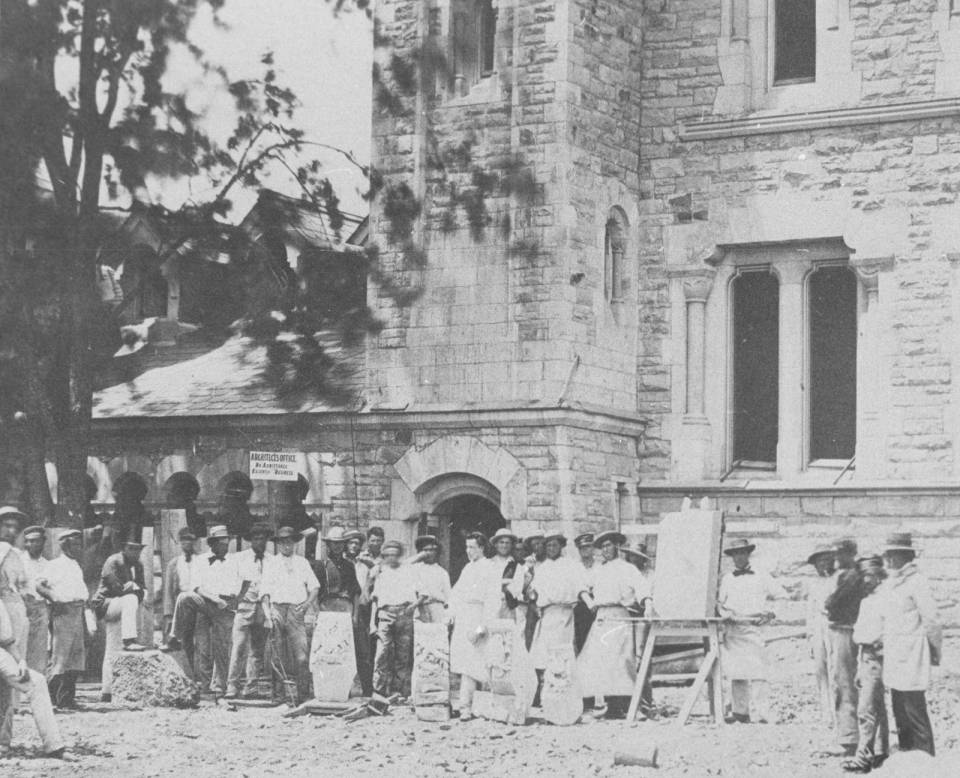 Group of more than 25 men standing in front of University College