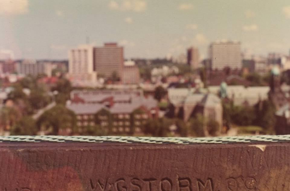 view from roof of University College with words "W.G. STORM", with modern cityscape beyond