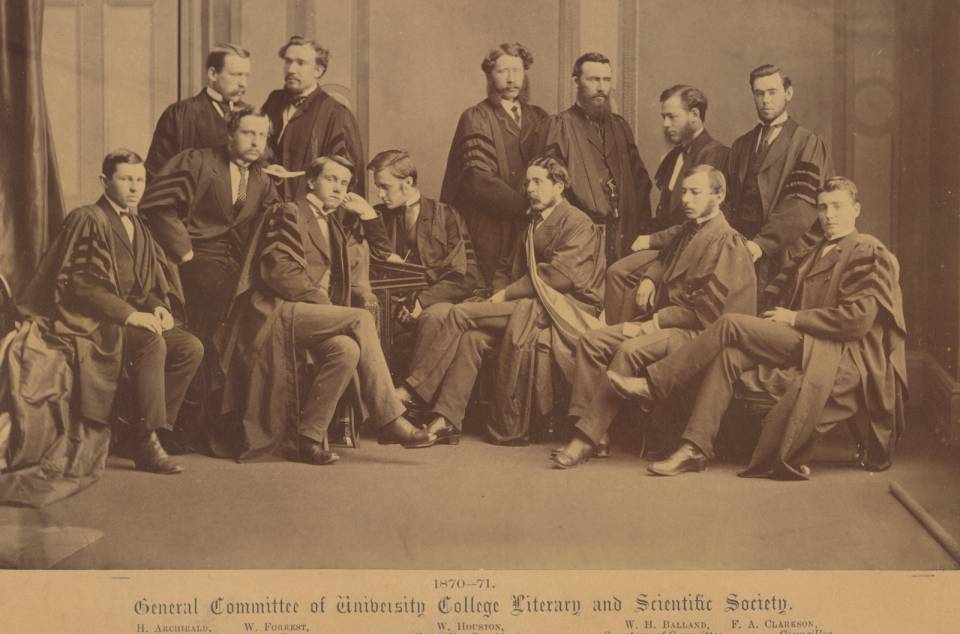 Twelve men in suits and academic robes