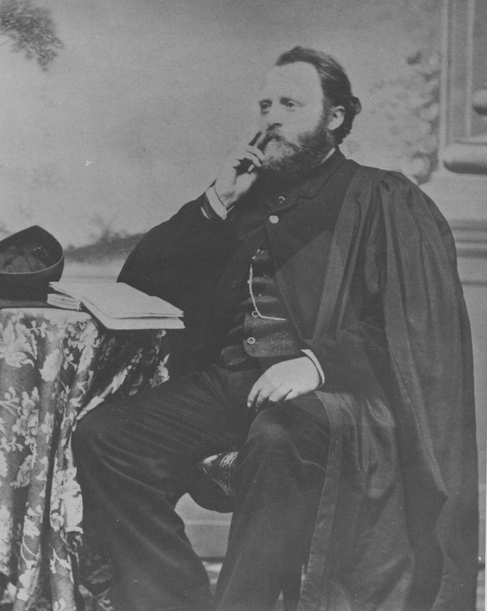 A man with a beard, wearing an academic robe