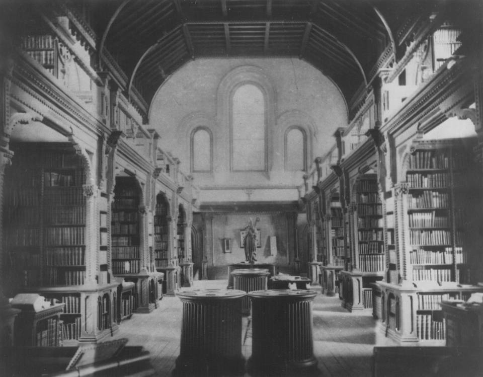 Library including book-lined alcoves and mezzanine