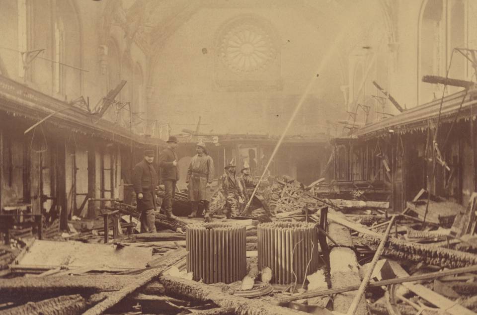 Museum destroyed by fire, with fire fighters