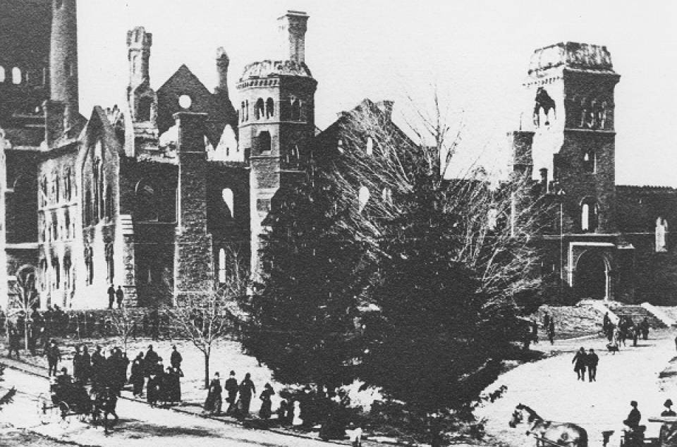 Damaged University College with pedestrians, carriages, and trees in foreground