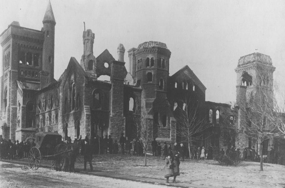 Damaged University College with pedestrians in foreground