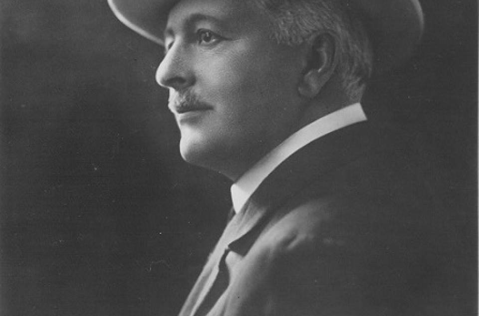 John Cunningham McLennan in suit and hat