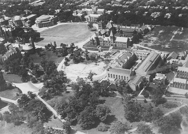 Aerial view of buildings, trees, and lawns