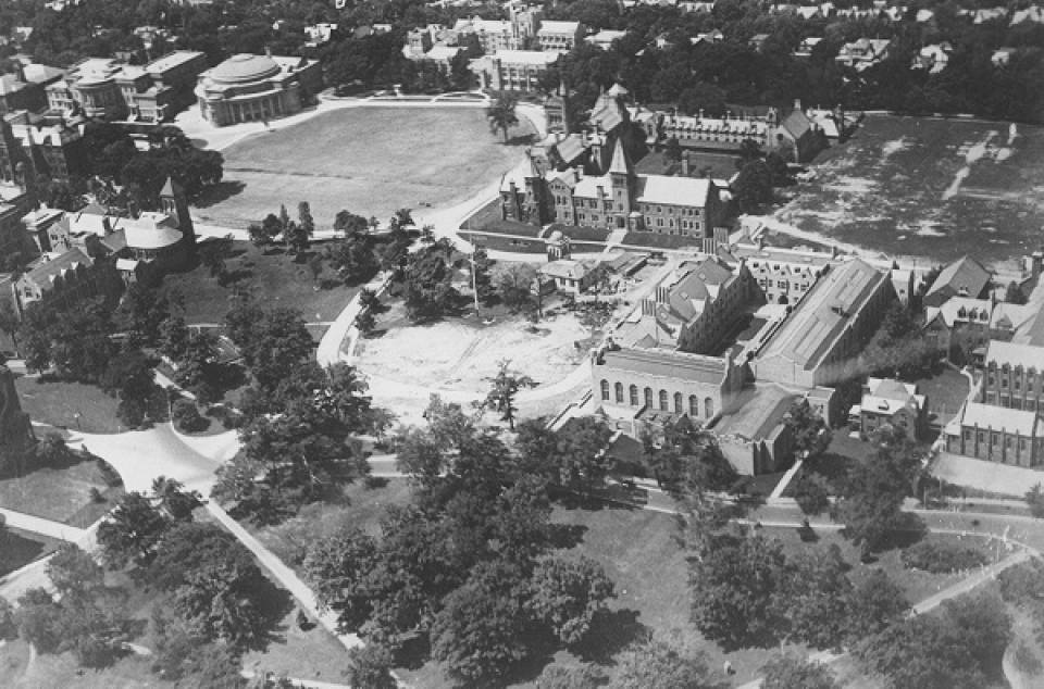 Aerial view of buildings, trees, and lawns