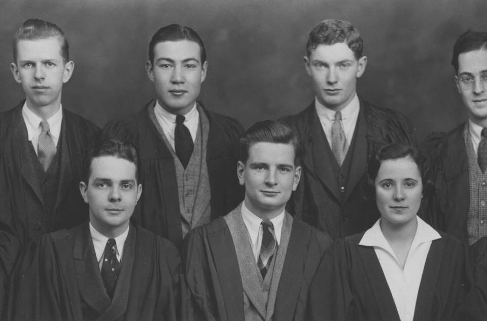 Eight men and one woman in academic robes