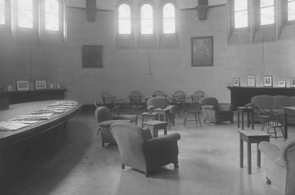 room with chairs, large windows, and a large table