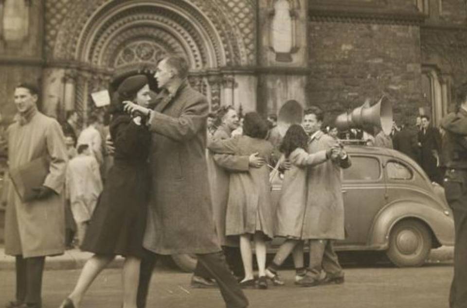 Men and women dancing in front of the main entrance of University College