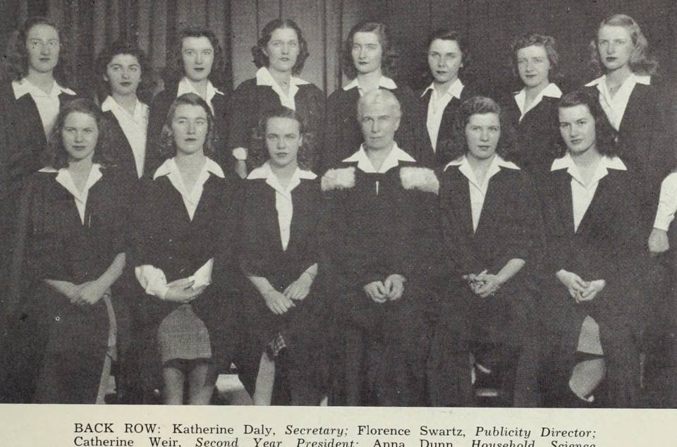 fourteen women wearing academic robes