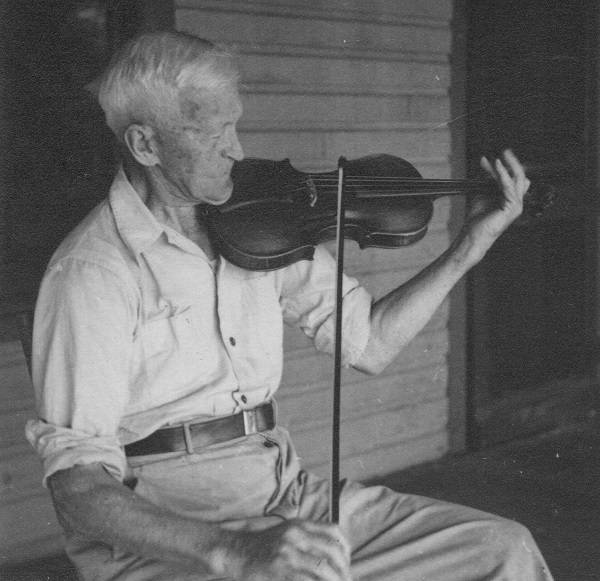Elderly man sitting on a porch, playing a violin