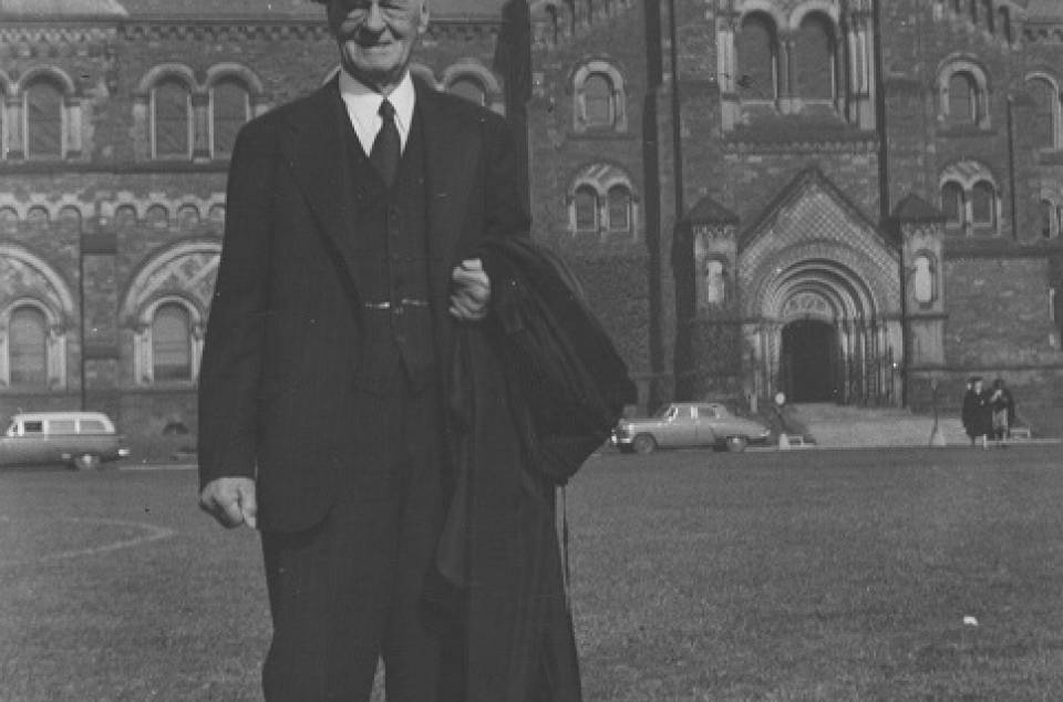 Malcolm Wallace wearing mortarboard in front of University College