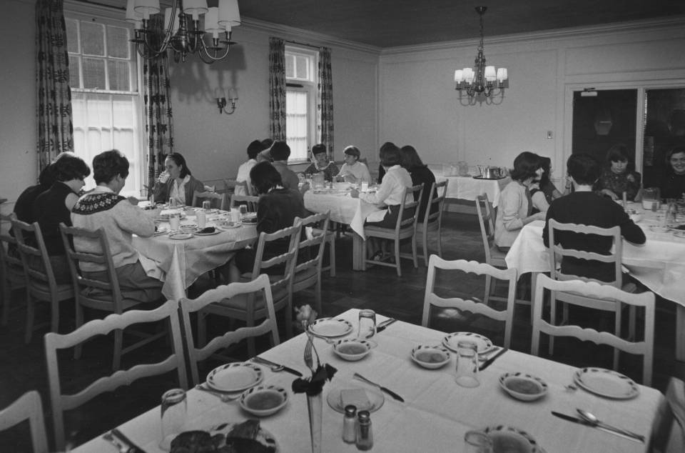 About 15 women eating at dining tables