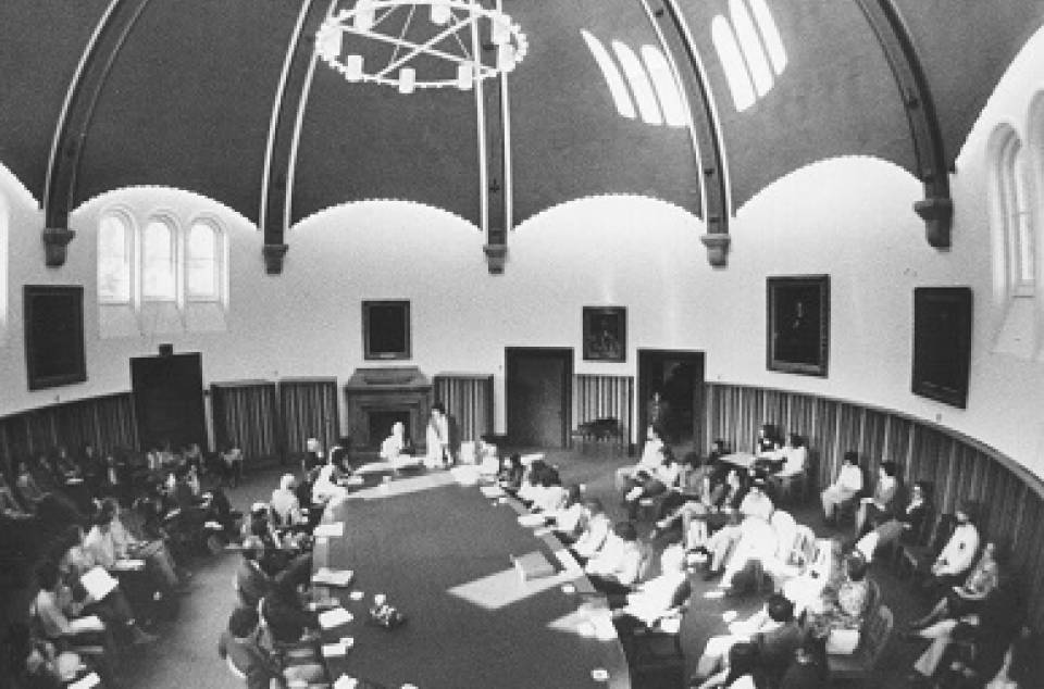 Many people seated around large table in Croft Chapter House