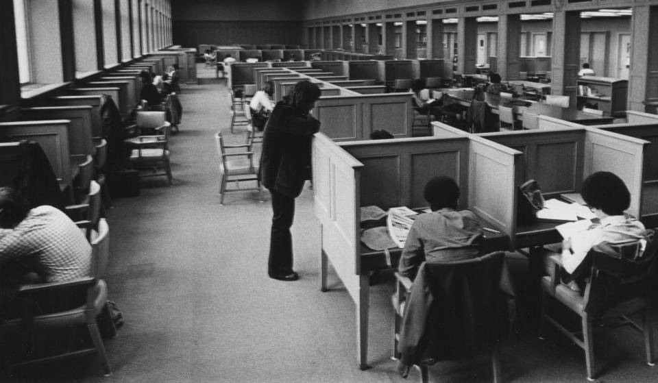 Students reading at study carrels or tables