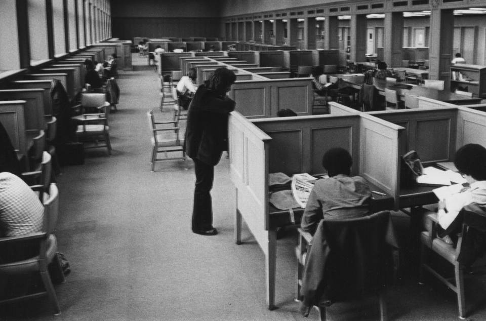 Students reading at study carrels or tables