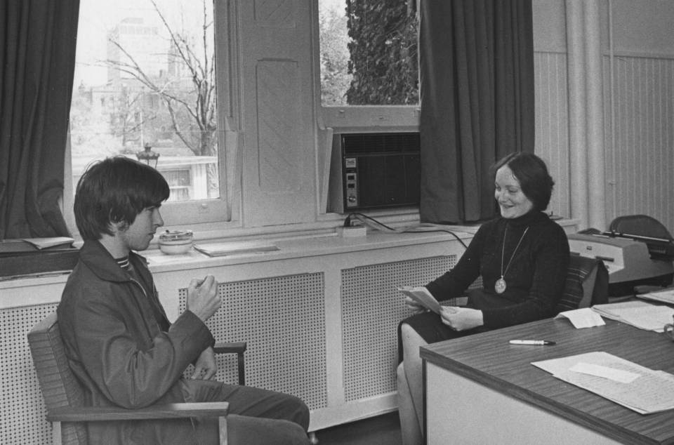 A woman talking with a young man