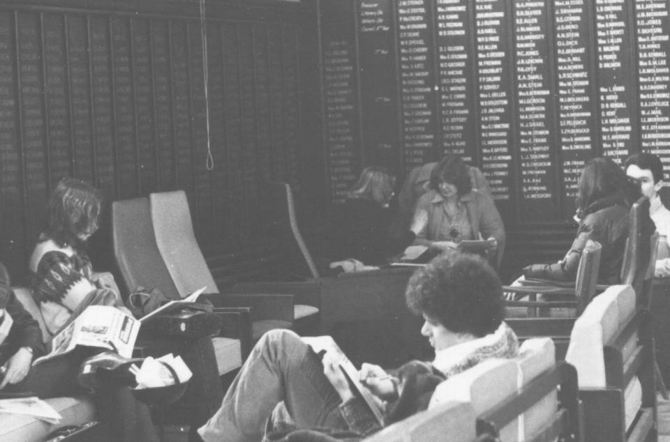 Five students reading, eating, or talking in a corner of the Junior Common Room