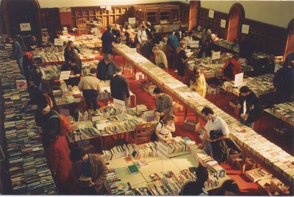 Customers browsing tables covered with books