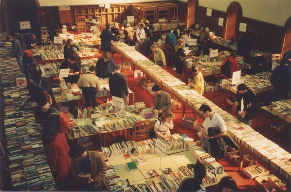 Customers browsing tables covered with books