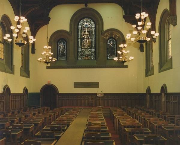 East Hall, including rows of empty desks and stained glass window
