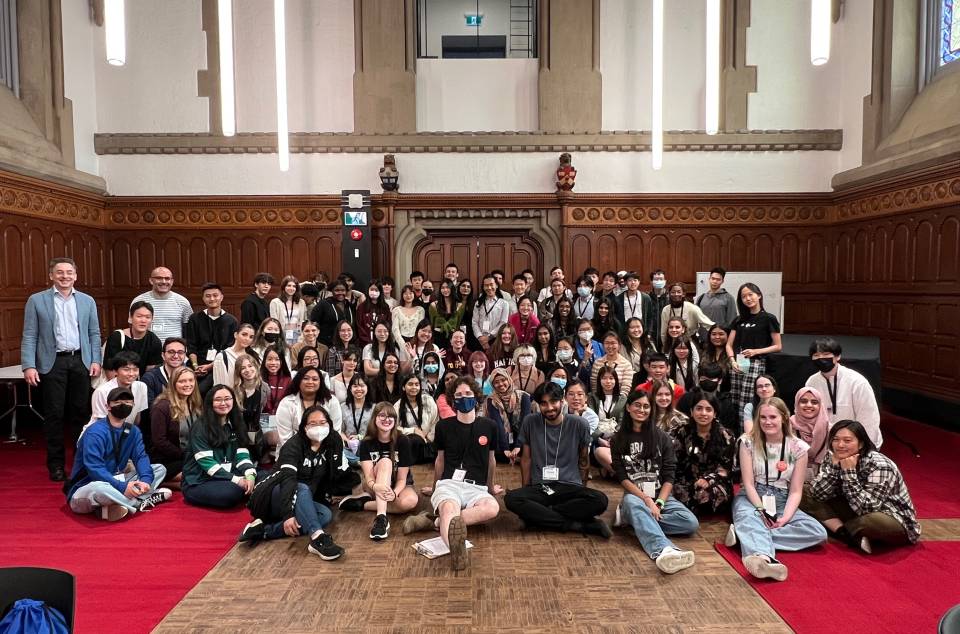 Group of UC students and staff sitting in the Clark Reading Room