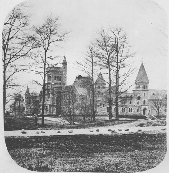 University College in background, road with rocks in foreground, trees
